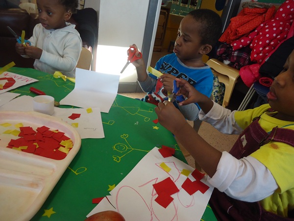 Children making collages at the craft table