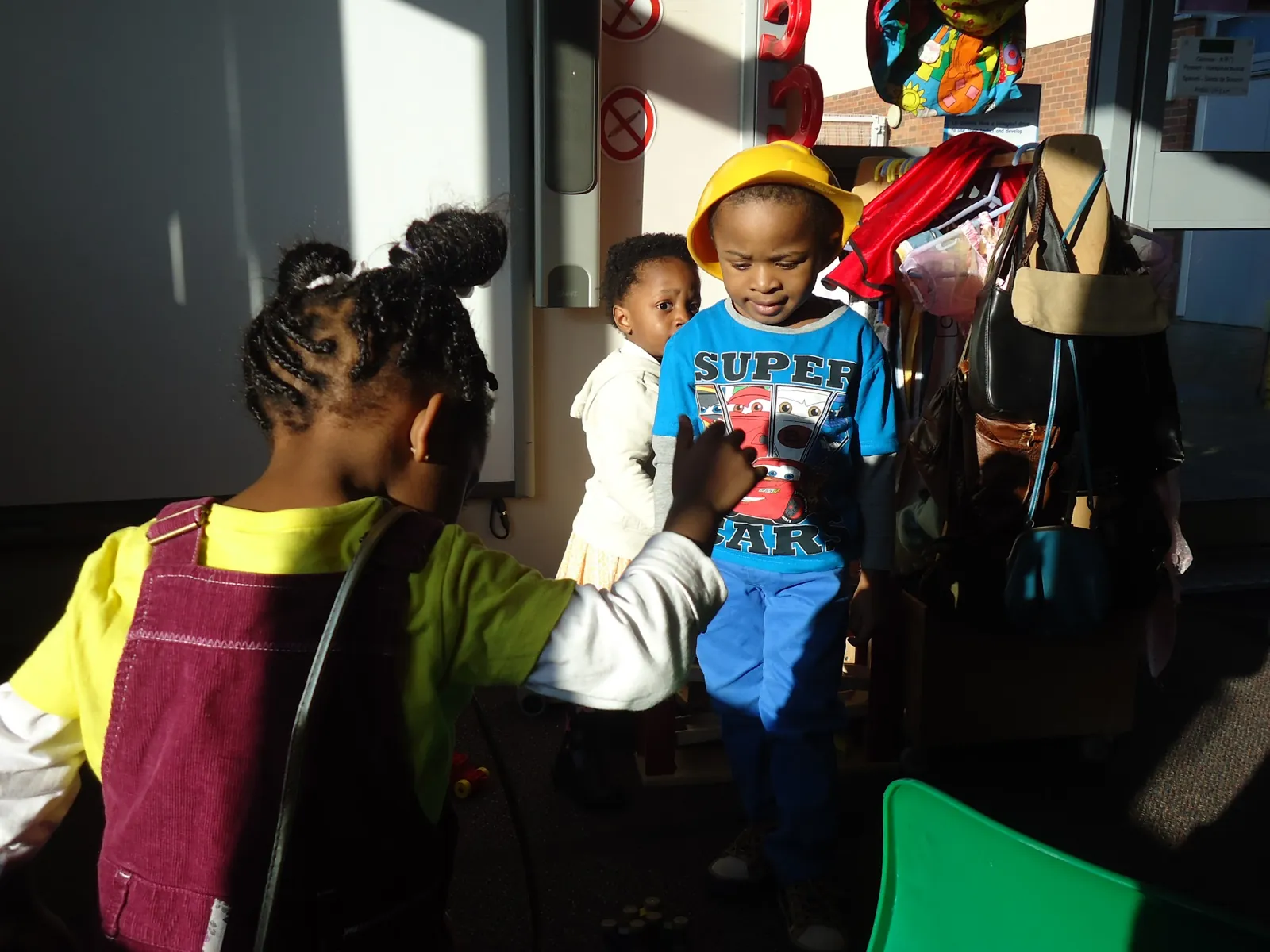 Children at the coat pegs getting ready to go out