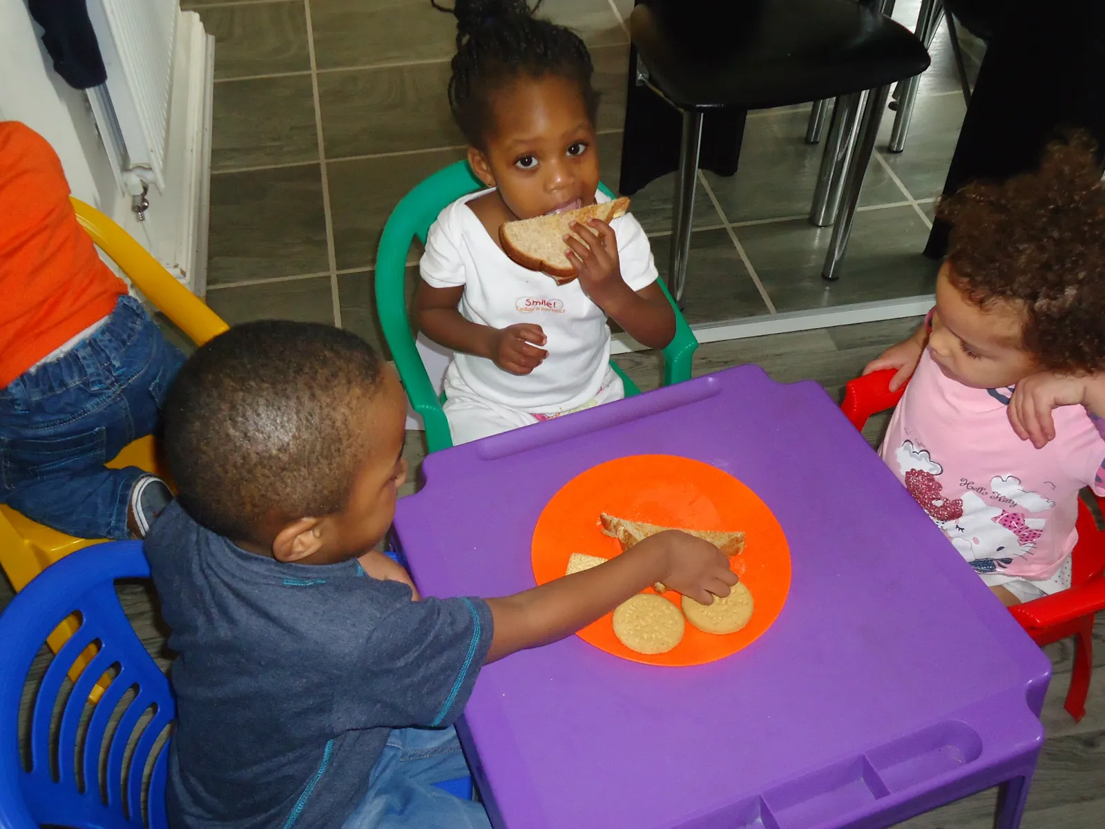 Children eating a snack together at the table