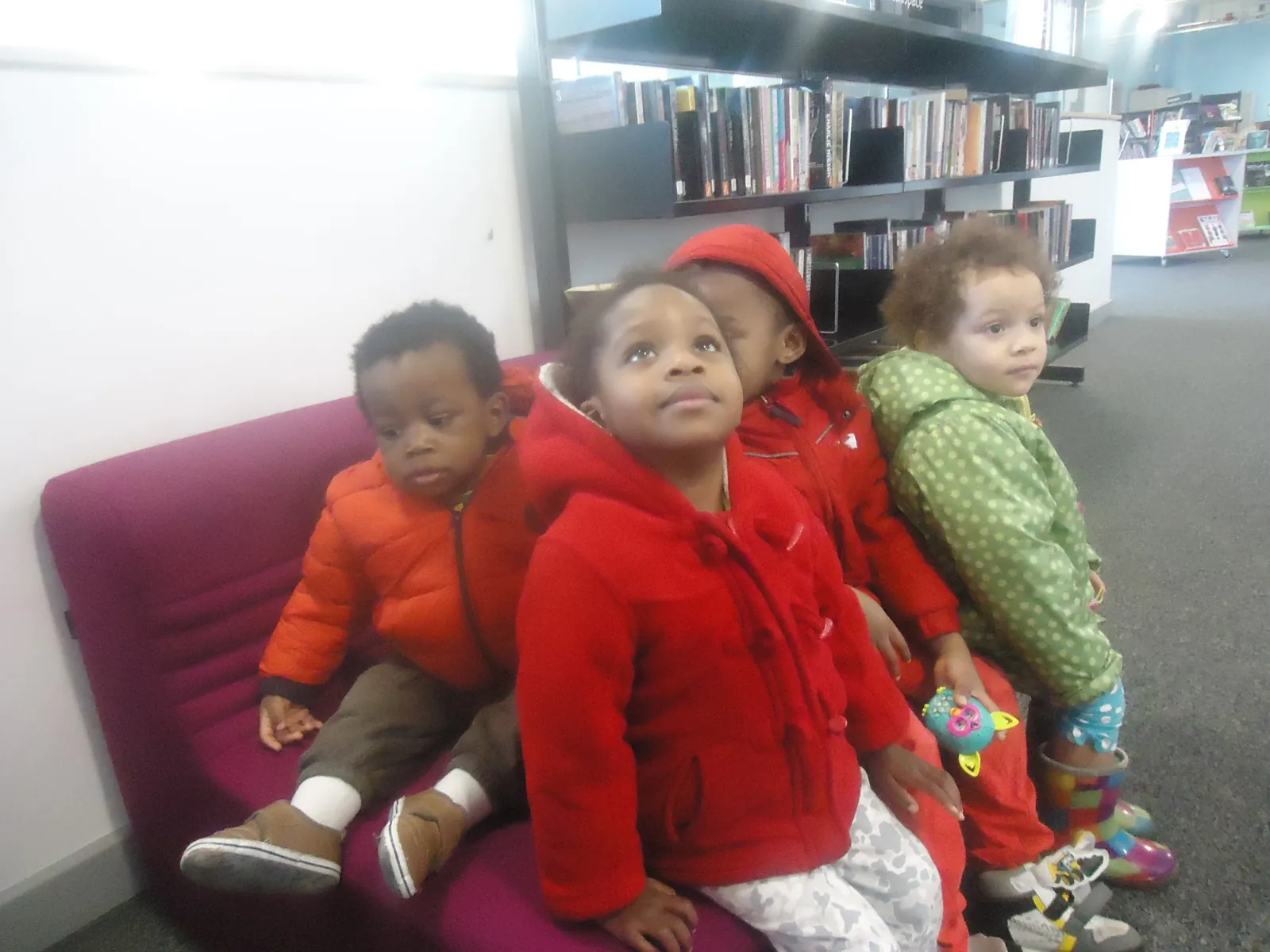 Children sitting together during a library visit